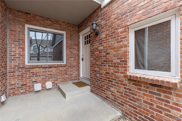 property entrance with brick siding