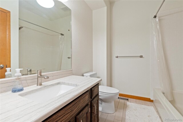 full bathroom with vanity, toilet, baseboards, visible vents, and shower / bath combination with curtain
