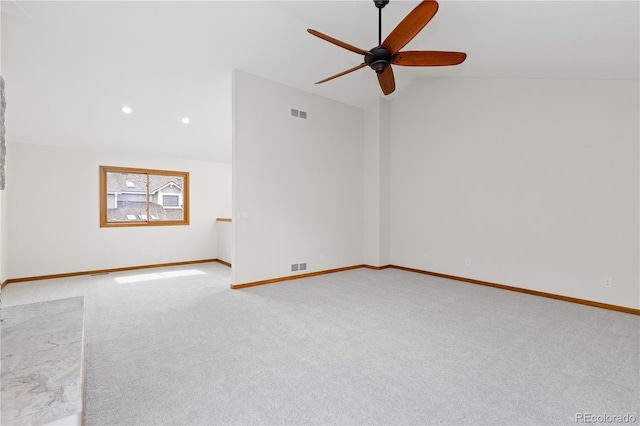 unfurnished room featuring lofted ceiling, ceiling fan, visible vents, and carpet