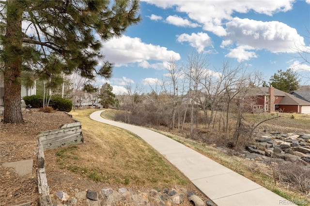 view of property's community with a lawn
