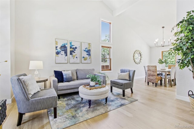 9810 Venneford Ranch Rd, Highlands Ranch, CO 80126 - living room with high vaulted ceiling, a chandelier, beamed ceiling, and light wood-style floors