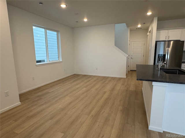 interior space featuring sink and light wood-type flooring