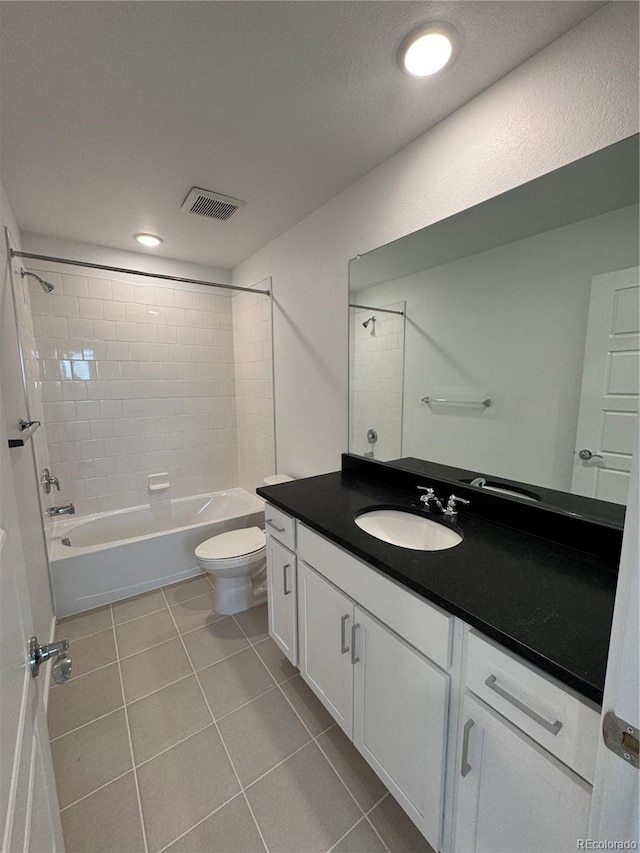 full bathroom with vanity, toilet, tiled shower / bath combo, and tile patterned flooring