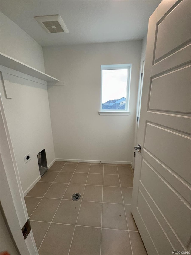 laundry area with light tile patterned floors and electric dryer hookup