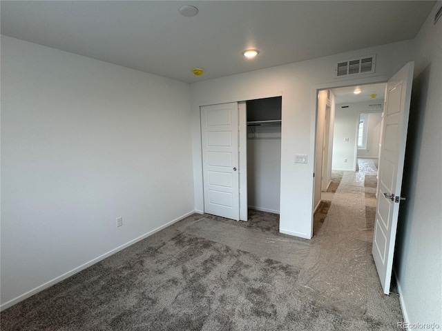 unfurnished bedroom featuring carpet flooring and a closet