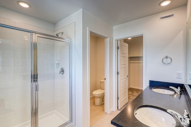 bathroom with vanity, an enclosed shower, tile patterned floors, and toilet