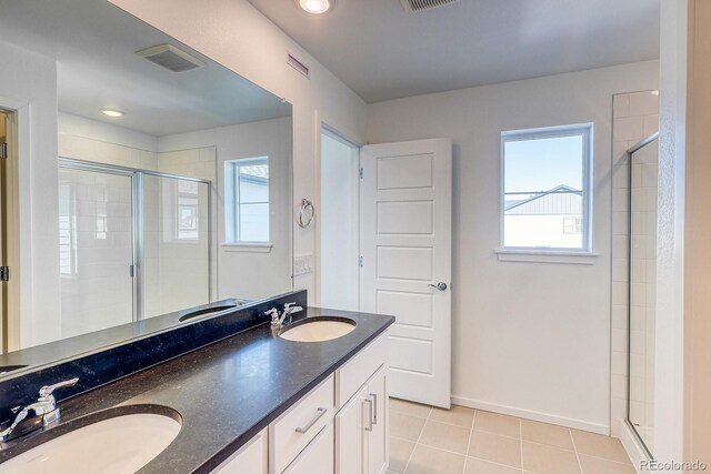 21242 E 63rd Dr, Aurora, CO 80019 - bathroom featuring plenty of natural light, a stall shower, and double vanity