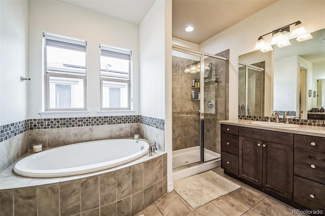 bathroom featuring a garden tub, a shower stall, vanity, and tile patterned floors