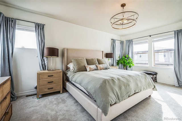 bedroom featuring baseboards, a chandelier, and light colored carpet