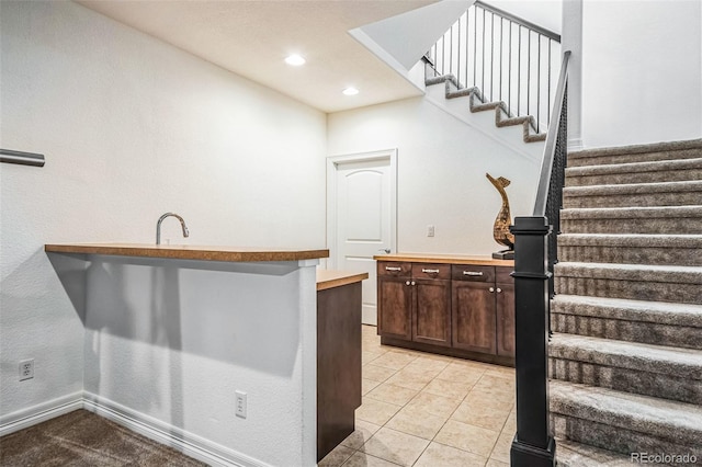 bar with light tile patterned floors, baseboards, stairs, and recessed lighting