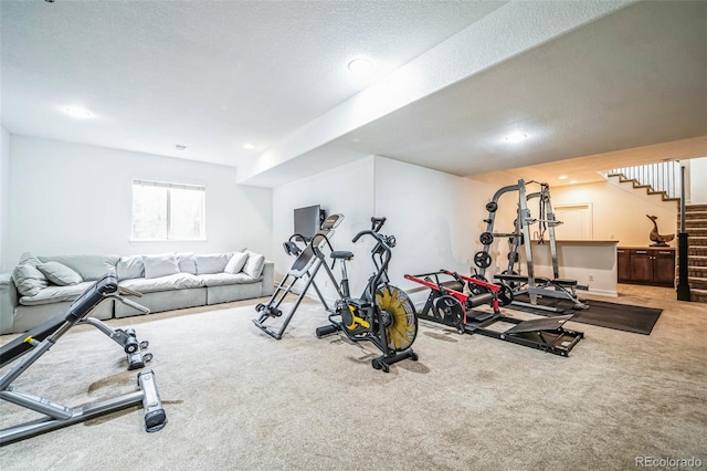 workout room featuring a textured ceiling, carpet floors, and recessed lighting