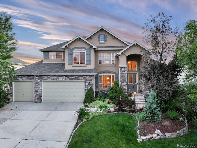 view of front of house with a yard and a garage