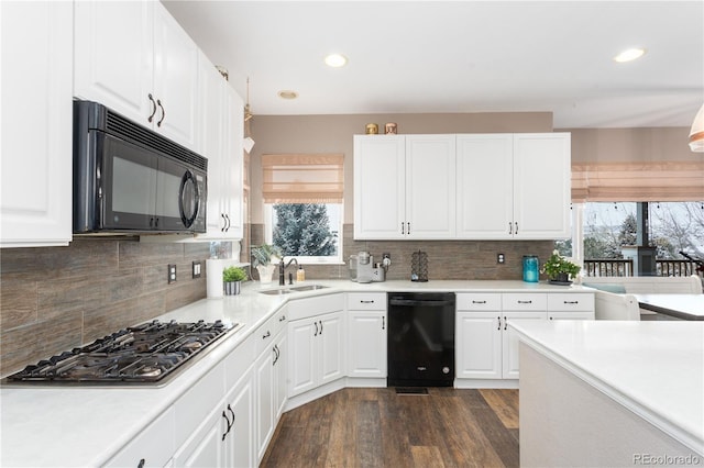 kitchen featuring black appliances, sink, decorative backsplash, dark hardwood / wood-style flooring, and white cabinetry