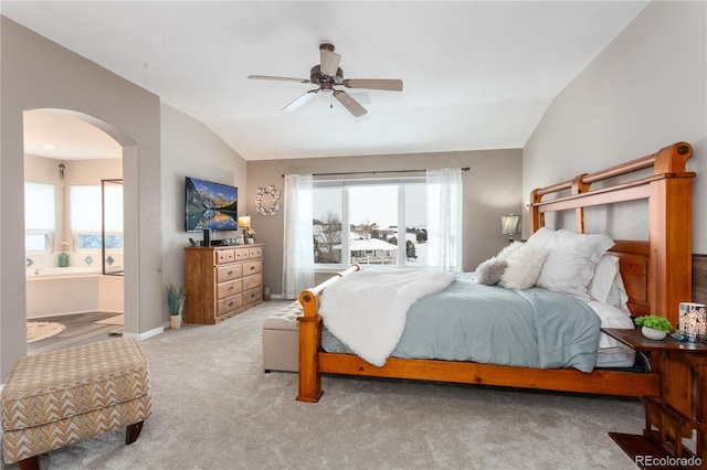 bedroom with ceiling fan, lofted ceiling, carpet floors, and ensuite bath