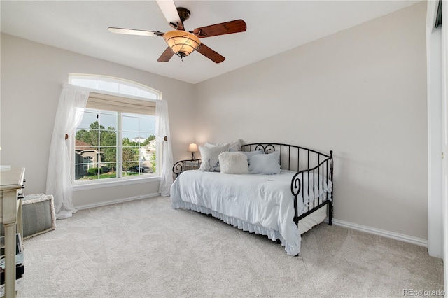 bedroom with ceiling fan and light colored carpet