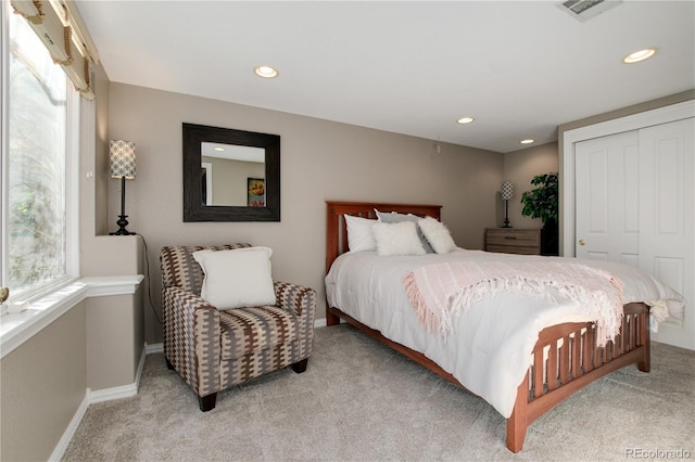 carpeted bedroom with multiple windows and a closet