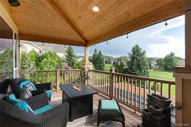 wooden terrace featuring a gazebo and an outdoor living space with a fire pit