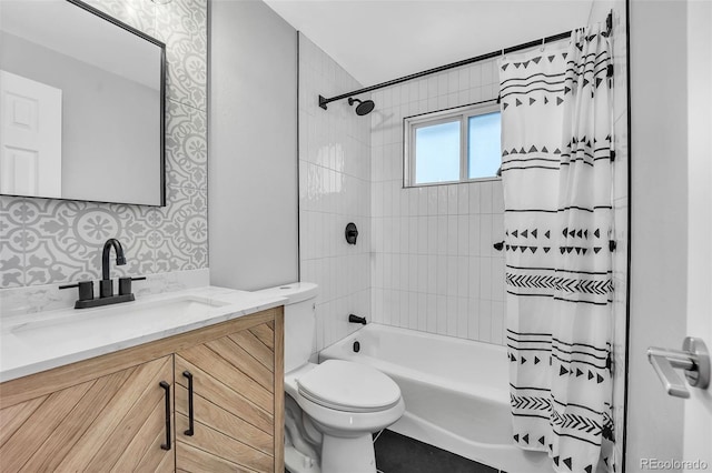 full bathroom featuring shower / bath combo, vanity, and toilet