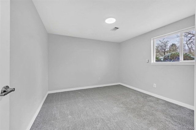 unfurnished room with visible vents, baseboards, and carpet floors