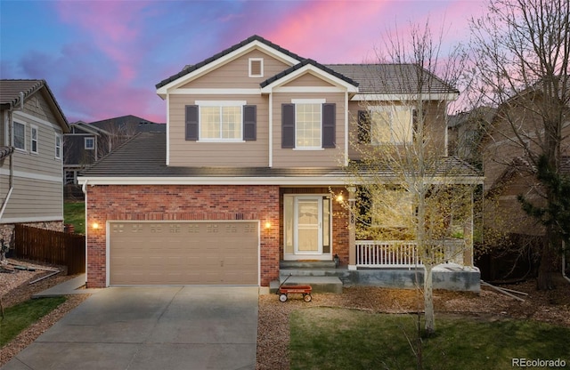 24880 E Euclid Pl, Aurora, CO 80016 - view of front of home with fence, concrete driveway, a porch, brick siding, and a garage
