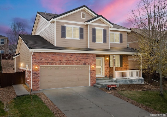24880 E Euclid Pl, Aurora, CO 80016 - view of front of property with fence, concrete driveway, an attached garage, a porch, and brick siding