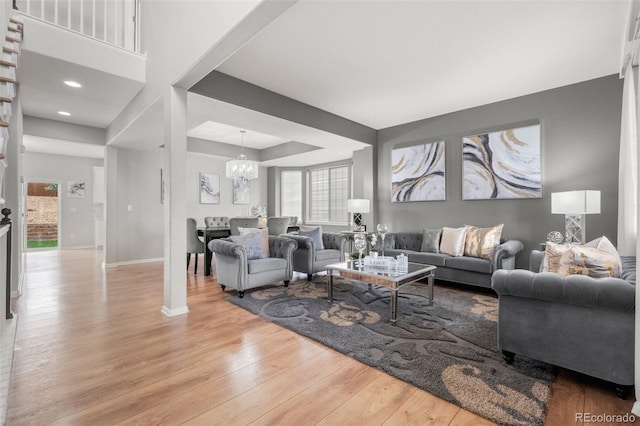 24880 E Euclid Pl, Aurora, CO 80016 - living area featuring baseboards, wood finished floors, a chandelier, and a tray ceiling