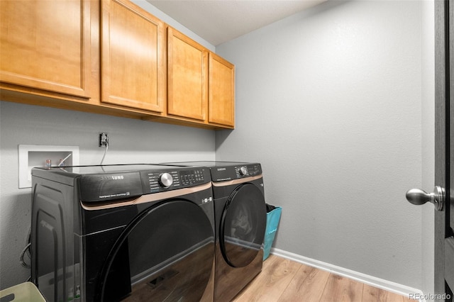 24880 E Euclid Pl, Aurora, CO 80016 - washroom featuring baseboards, independent washer and dryer, cabinet space, and light wood-style flooring