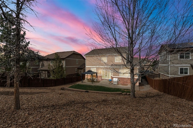 24880 E Euclid Pl, Aurora, CO 80016 - yard at dusk with a fenced backyard, a gazebo, and a patio