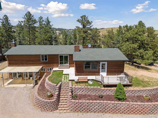 view of front of property with a patio and a wooden deck