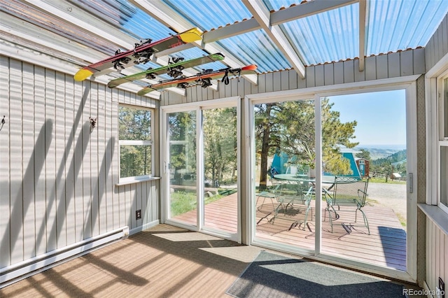 unfurnished sunroom featuring a baseboard heating unit