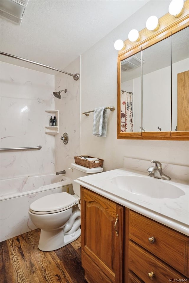 full bathroom with hardwood / wood-style flooring, vanity, toilet, and tub / shower combination