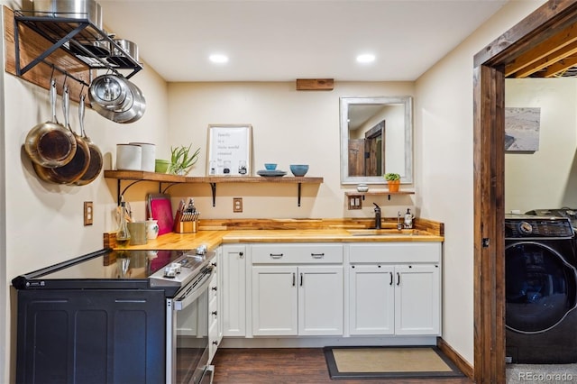 kitchen featuring white cabinetry, sink, butcher block countertops, washer / clothes dryer, and electric stove