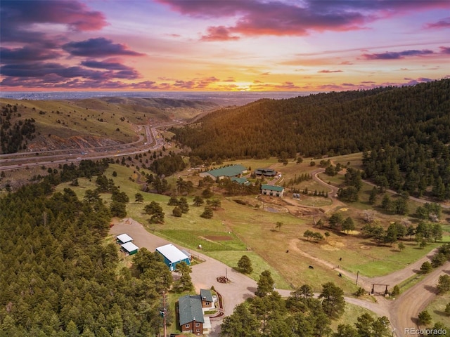 aerial view at dusk featuring a rural view