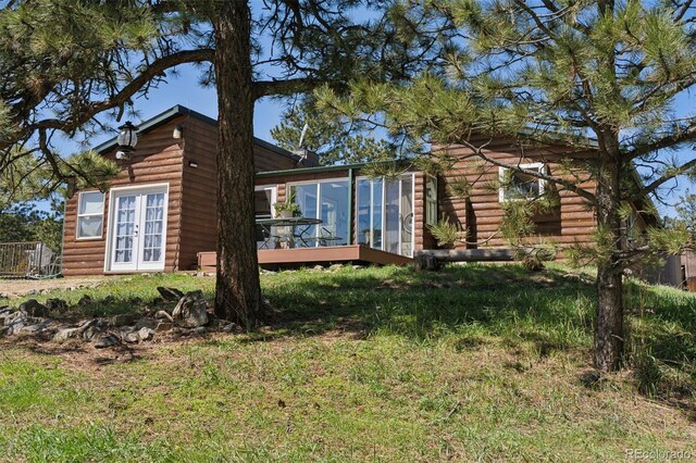 rear view of house with french doors and a wooden deck