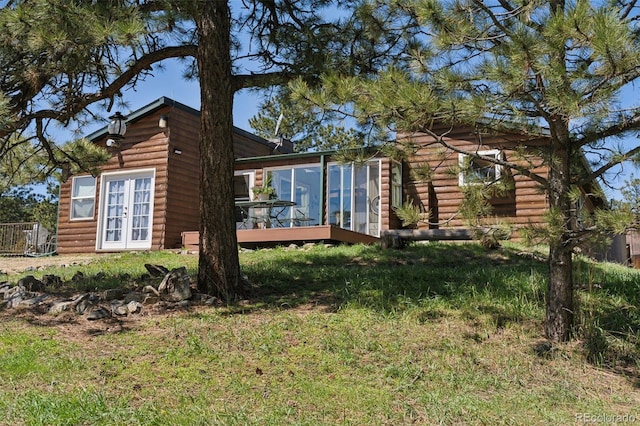 view of side of property featuring faux log siding and a deck