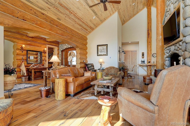 living room with a fireplace, wooden ceiling, light hardwood / wood-style flooring, ceiling fan, and high vaulted ceiling