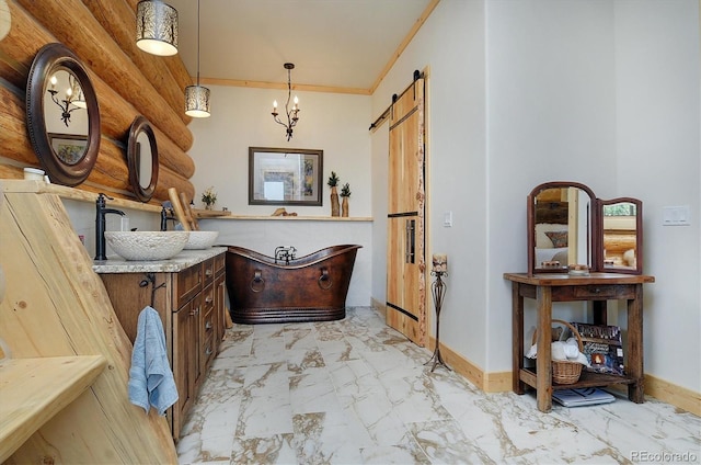 bathroom featuring a washtub, ornamental molding, an inviting chandelier, and vanity