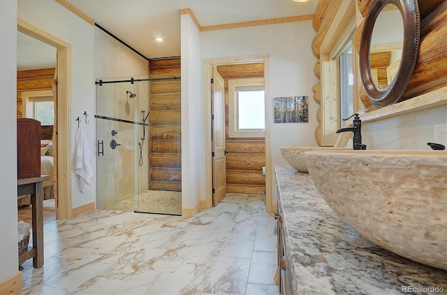 bathroom with a shower with shower door, ornamental molding, and vanity