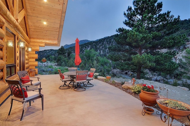 view of patio / terrace with outdoor dining area and a mountain view