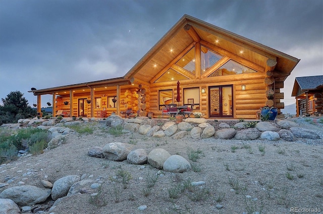 rear view of house featuring log exterior