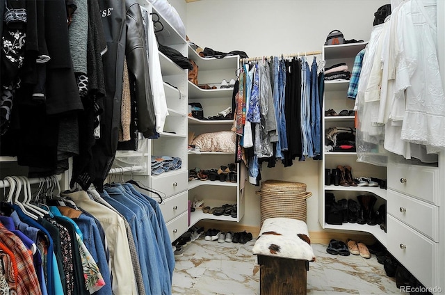 spacious closet featuring marble finish floor