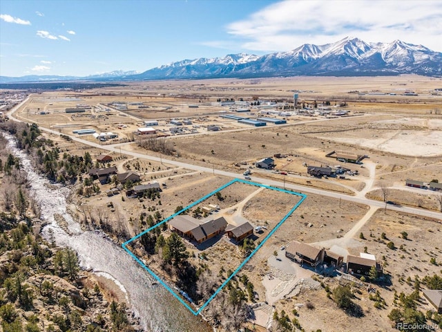 aerial view featuring a rural view, view of desert, and a mountain view