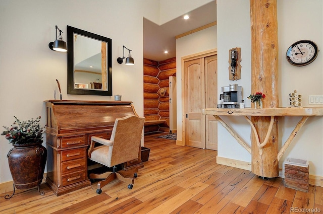 office space with log walls, baseboards, hardwood / wood-style floors, and recessed lighting