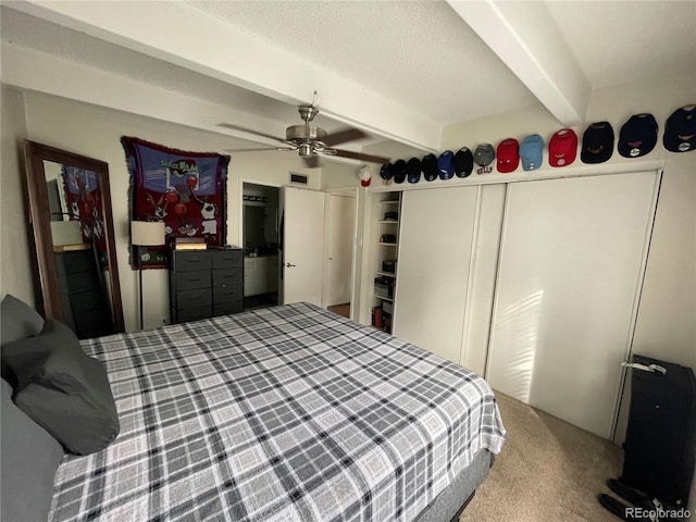9995 E Harvard Ave Unit 177, Denver, CO 80231 - bedroom featuring beamed ceiling, carpet floors, a ceiling fan, and a textured ceiling