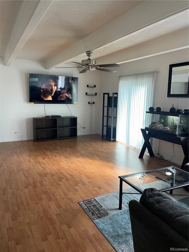 9995 E Harvard Ave Unit 177, Denver, CO 80231 - living area with beamed ceiling, wood finished floors, a ceiling fan, baseboards, and a textured ceiling