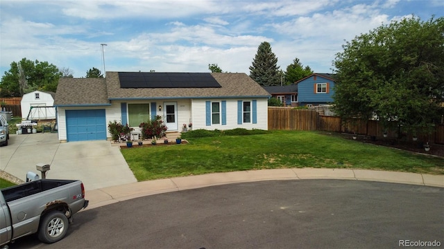 19258 E Kansas Dr, Aurora, CO 80017 - view of front of house with an attached garage, roof mounted solar panels, concrete driveway, and roof with shingles
