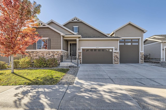 craftsman house featuring a front yard and a garage