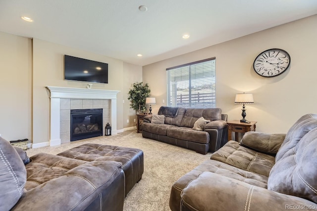 carpeted living room featuring a tiled fireplace