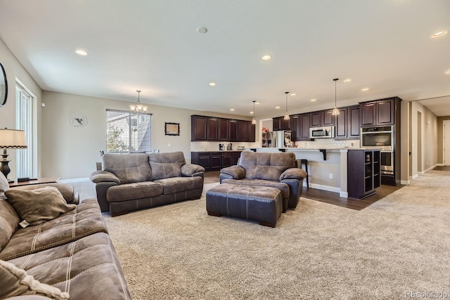 living room with an inviting chandelier and dark carpet