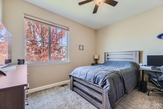 carpeted bedroom featuring ceiling fan and multiple windows